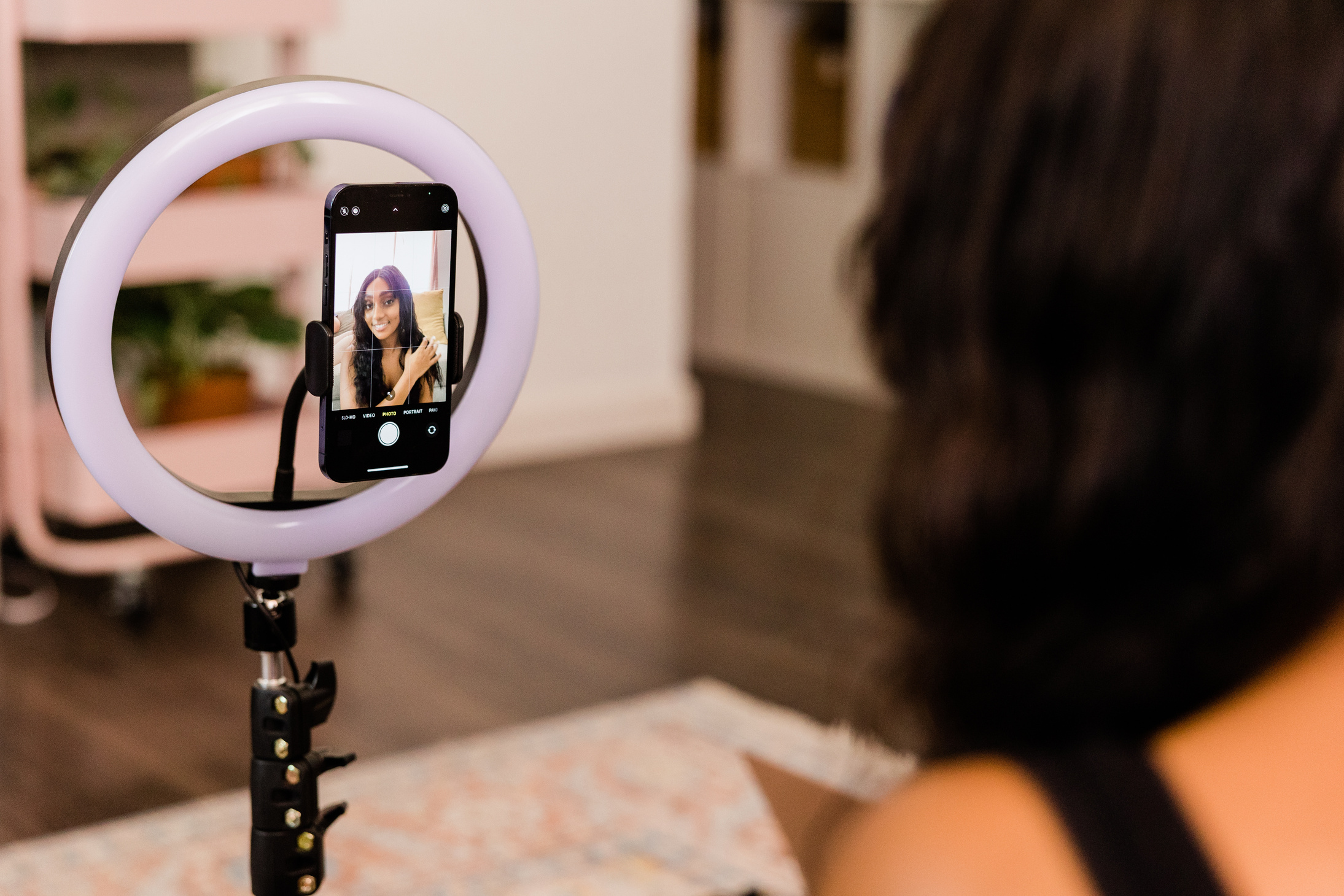 Woman Recording Herself on Smartphone with Ring Light
